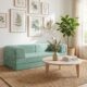 Green convertible couch inside living room.