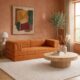 Orange convertible couch inside living room.