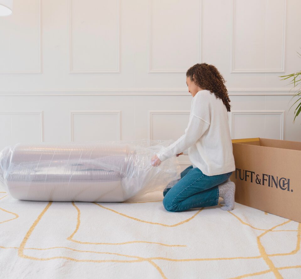 Young girl opening a couch in a bag.