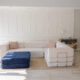 Large L Shaped couch with blue ottoman.