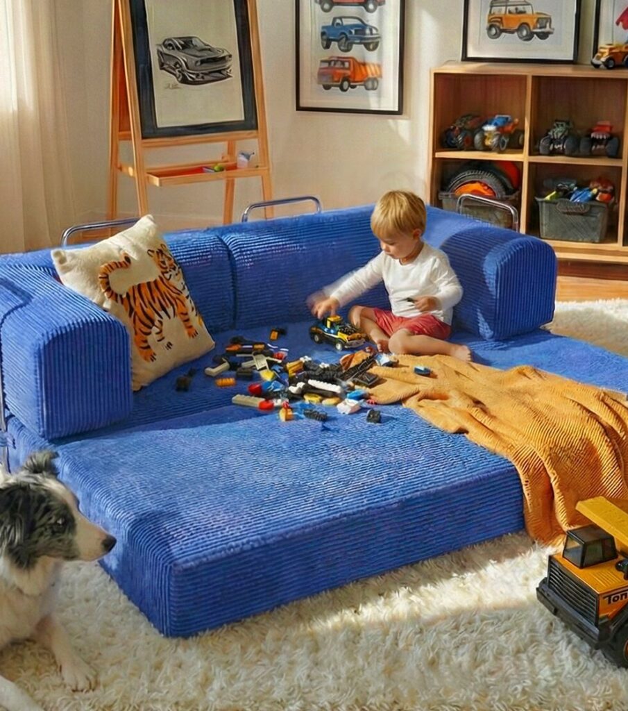 Baby sitting on blue modular couch.
