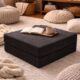 Modular ottoman with coffee and book sitting on it.
