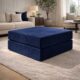 Dark blue modular ottoman with coffee and book sitting on it.