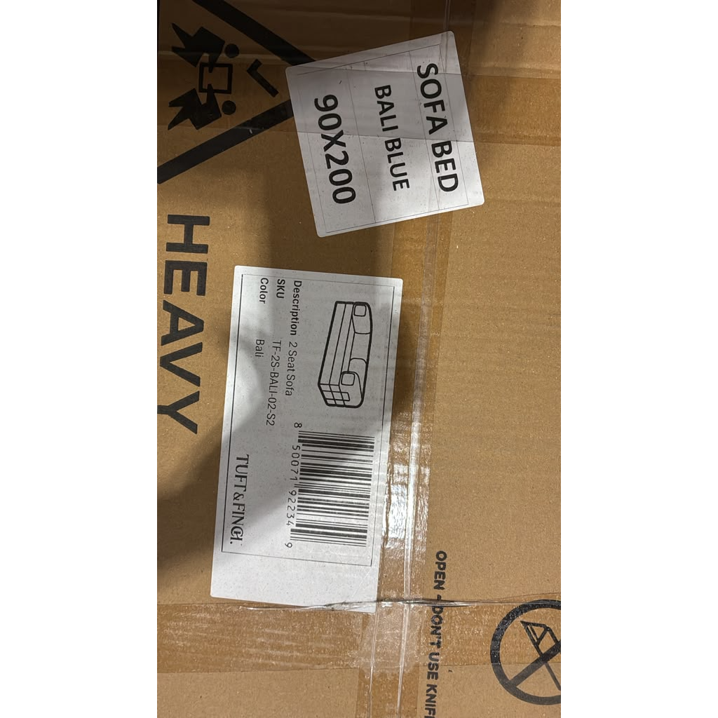 Up close photo of label showing that couch is heavy.