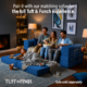 Family sitting on blue boneless sofa in expandable configuration with feet on blue foam ottoman.